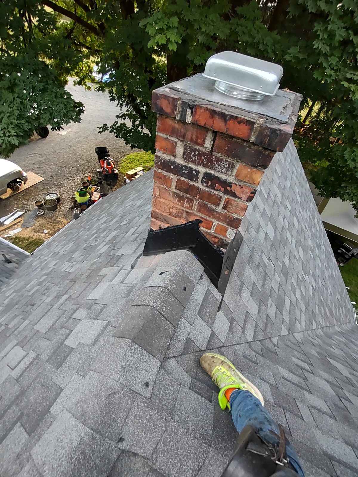 Brick chimney reflashed on a brand-new architectural shingle roof